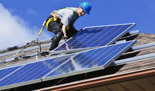 home rooftop, worker, solar panels being installed