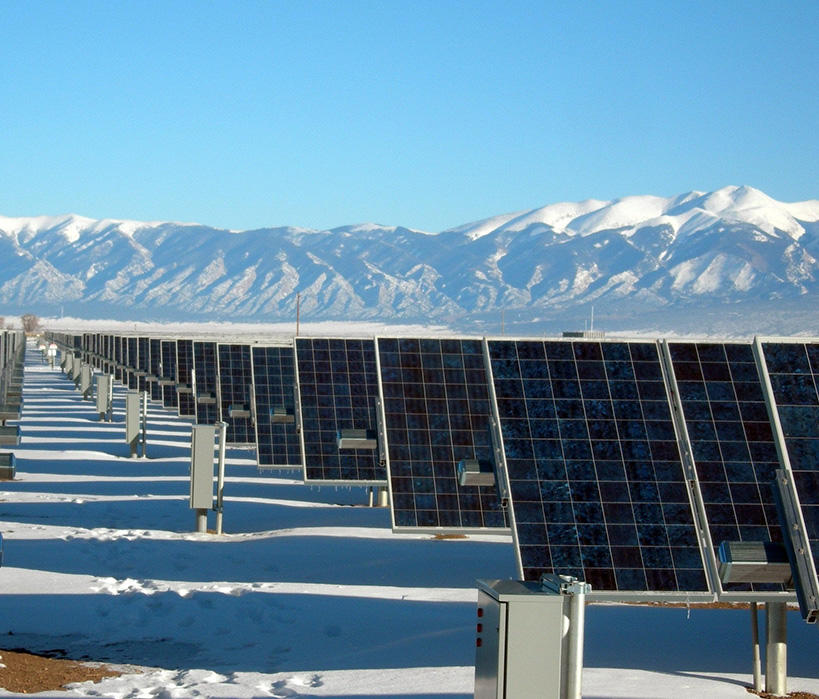 Rows of Solar Panels in a Snow Covered Field