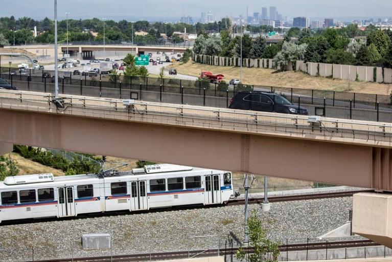 Colorado RTD Transit shown in front of Denver skyline