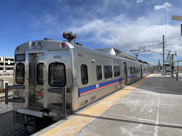 An RTD train parked at a light rail station.
