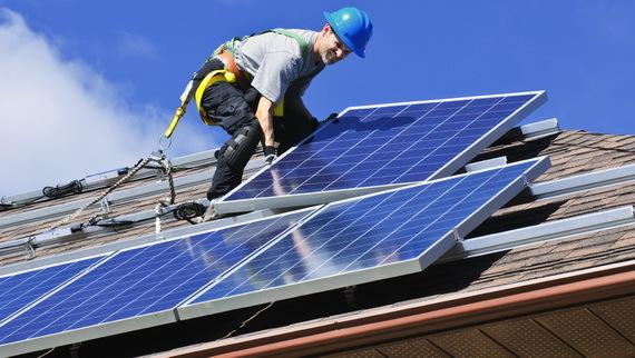 home rooftop, worker, solar panels being installed