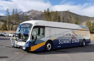 Summit stage transit bus in front of mountains
